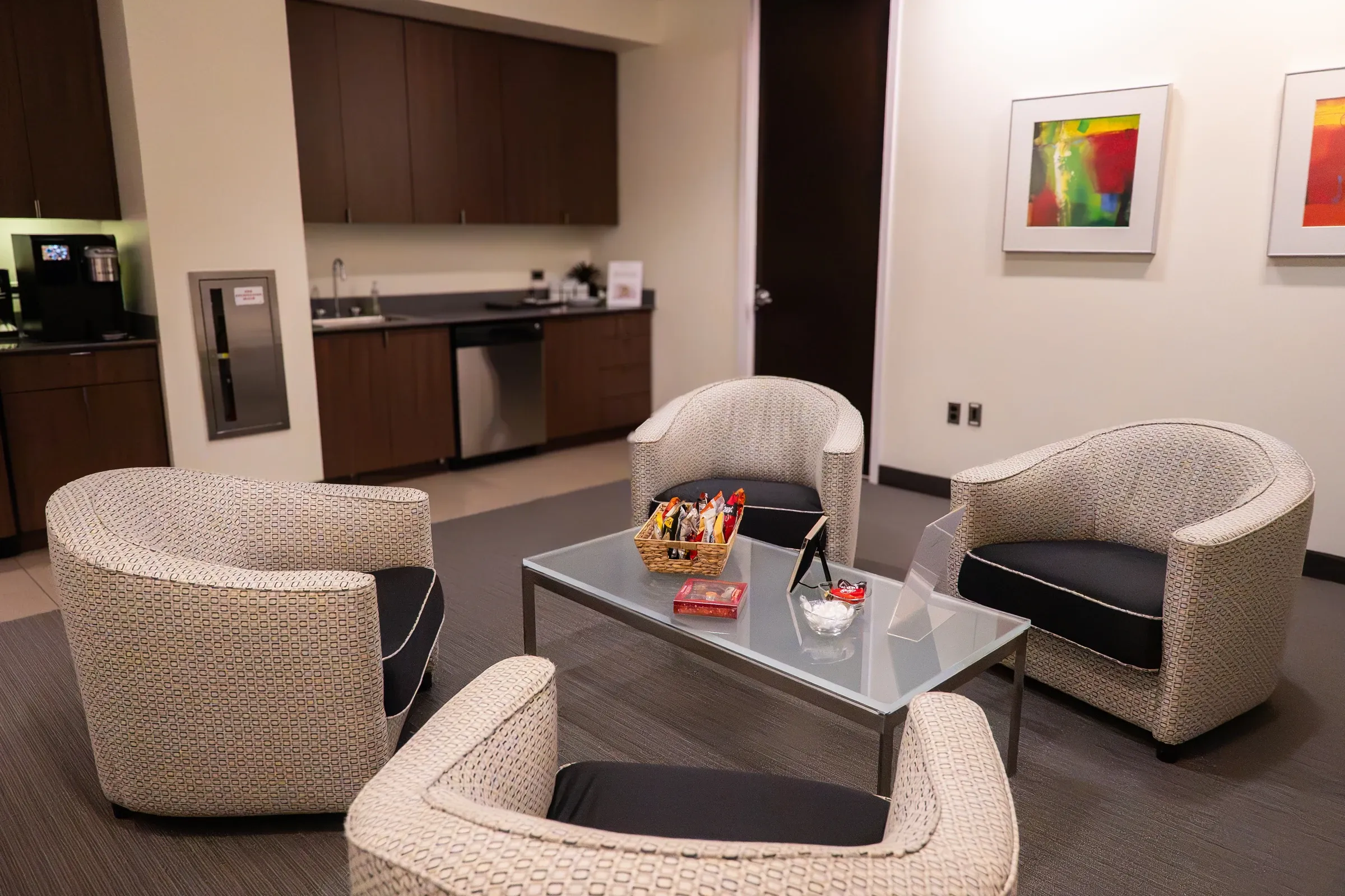 Skyline Suite private client lounge with armchairs and a coffee table